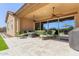 Inviting covered patio with ceiling fans, tiled flooring and comfortable seating offers a serene outdoor living space at 6125 E Hodges St, Cave Creek, AZ 85331