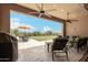Relaxing covered patio with ceiling fans and comfortable seating overlooking the large backyard at 6125 E Hodges St, Cave Creek, AZ 85331