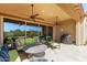 Elegant covered patio with ceiling fans, outdoor grill, with view of the green backyard and swimming pool at 6125 E Hodges St, Cave Creek, AZ 85331