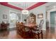 Elegant dining room with hardwood floors, traditional table setting, and large window with natural light at 6125 E Hodges St, Cave Creek, AZ 85331