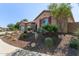 Landscaped front yard with desert flora and a charming stucco home with a two-car garage at 6125 E Hodges St, Cave Creek, AZ 85331