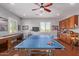 Spacious game room with a ping pong table, shuffleboard, wet bar, and hardwood floors, perfect for entertainment at 6125 E Hodges St, Cave Creek, AZ 85331