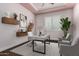 Contemporary home office featuring a modern desk, floating shelves, and comfortable seating, offering a productive workspace at 6125 E Hodges St, Cave Creek, AZ 85331