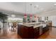 Open-concept kitchen featuring a large island, granite countertops, stainless steel appliances, and wood floors at 6125 E Hodges St, Cave Creek, AZ 85331