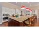 Beautiful kitchen with a large granite island, breakfast bar, pendant lighting, and modern appliances at 6125 E Hodges St, Cave Creek, AZ 85331