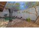 Backyard with privacy fence, small putting green, and shade tree at 6441 E Colby St, Mesa, AZ 85205