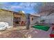 Wide shot of backyard showing putting green, covered patio, and mature shade trees at 6441 E Colby St, Mesa, AZ 85205