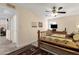 Bedroom with wooden bed frame, large area rug and a view into an adjacent room at 6441 E Colby St, Mesa, AZ 85205