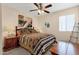 Comfortable bedroom with Southwestern style decor, ceiling fan, and a unique headboard with matching side tables at 6441 E Colby St, Mesa, AZ 85205