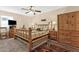 Bedroom with a wooden bed, matching wooden furniture and a patterned rug at 6441 E Colby St, Mesa, AZ 85205