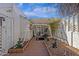 Secluded courtyard featuring a covered patio, tiled walkway, decorative plants, and elegant exterior architectural details at 6441 E Colby St, Mesa, AZ 85205