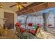 Charming covered patio with dining area, ceiling fan and door to backyard at 6441 E Colby St, Mesa, AZ 85205