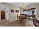 Cozy dining area with vintage light fixture, slider to covered patio, and a bar area at 6441 E Colby St, Mesa, AZ 85205