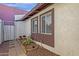 Exterior view showcasing a garden bed, and brown-trimmed windows, offering curb appeal at 6441 E Colby St, Mesa, AZ 85205