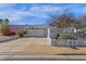 Charming home features a two-car garage, mature landscaping, and a well-maintained yard, with a white lattice fence at 6441 E Colby St, Mesa, AZ 85205