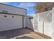 A well-maintained two-car garage and cozy courtyard, featuring a lattice fence and easy access to the front entryway at 6441 E Colby St, Mesa, AZ 85205