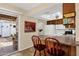 Bright kitchen featuring bar stool seating and sliding glass door access to the backyard patio at 6441 E Colby St, Mesa, AZ 85205