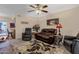 Cozy living room featuring reclining chairs, a ceiling fan, and a stylish patterned rug at 6441 E Colby St, Mesa, AZ 85205