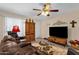 Bright living room with a TV, recliner seating, and a decorative rug at 6441 E Colby St, Mesa, AZ 85205