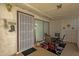 Covered patio includes a sliding glass door, seating, rug, and a screen door perfect for relaxing and entertaining at 6441 E Colby St, Mesa, AZ 85205