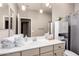 Bright bathroom featuring vanity and a decorative mirror at 6608 W Saguaro Park Ln, Glendale, AZ 85310
