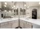 Bright bathroom featuring double sinks, vanity, and a glass-enclosed shower with tiled floors at 6608 W Saguaro Park Ln, Glendale, AZ 85310
