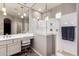 Bright bathroom featuring double sinks, vanity, and a glass-enclosed shower with tiled floors at 6608 W Saguaro Park Ln, Glendale, AZ 85310