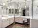 Bright bathroom featuring double sinks, vanity, and a glass-enclosed shower with tiled floors at 6608 W Saguaro Park Ln, Glendale, AZ 85310