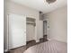 Neutral bedroom with closet and en suite bathroom at 6608 W Saguaro Park Ln, Glendale, AZ 85310