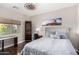 Stylish bedroom with nature artwork and dark hardwood floors at 6608 W Saguaro Park Ln, Glendale, AZ 85310