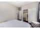 Neutral bedroom with closet and ottoman seating at 6608 W Saguaro Park Ln, Glendale, AZ 85310