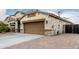 Home featuring a two-car garage and a desert-style front yard at 6608 W Saguaro Park Ln, Glendale, AZ 85310