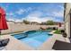 Beautiful backyard pool with a Baja step, perfect for relaxing or entertaining guests at 6608 W Saguaro Park Ln, Glendale, AZ 85310
