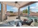 Covered backyard patio features comfortable wicker furniture overlooking a pool with desert landscaping at 6777 W Tether Trl, Peoria, AZ 85383