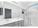 Bathroom featuring double sinks, a large mirror, storage and a glass shower at 6777 W Tether Trl, Peoria, AZ 85383