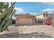 Single-story house featuring desert landscaping, a two-car garage, and a concrete driveway at 6777 W Tether Trl, Peoria, AZ 85383