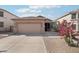 Charming single-story home featuring a desert landscape and a two-car garage at 6777 W Tether Trl, Peoria, AZ 85383