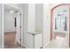 Hallway view showcasing arched entryway, wood look floors, and modern white trim at 6777 W Tether Trl, Peoria, AZ 85383