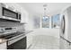 Bright kitchen featuring stainless steel appliances, tile floors, and a breakfast nook at 6777 W Tether Trl, Peoria, AZ 85383