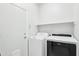 Bright laundry room with included washer and dryer, and white shelving at 6777 W Tether Trl, Peoria, AZ 85383