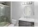 Bright bathroom featuring a shower and tub combination, modern vanity, mirror, and toilet at 6920 W Via Montoya Dr, Glendale, AZ 85310