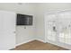 A cozy bedroom with a door to the hallway, and an exterior door with glass windows at 6920 W Via Montoya Dr, Glendale, AZ 85310