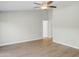 Neutral tone bedroom with ceiling fan and laminate flooring at 6920 W Via Montoya Dr, Glendale, AZ 85310