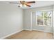 Minimalist bedroom with a ceiling fan, window with blinds, and vinyl floor at 6920 W Via Montoya Dr, Glendale, AZ 85310