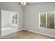 Cozy bedroom with lots of sunlight with a ceiling fan and an open entry to another room at 6920 W Via Montoya Dr, Glendale, AZ 85310