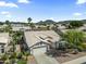Aerial view of home with a two-car garage, desert landscaping, and mountain views at 6920 W Via Montoya Dr, Glendale, AZ 85310