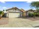 Front exterior of a single-story home with a two-car garage and desert landscaping at 6920 W Via Montoya Dr, Glendale, AZ 85310