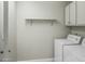 A functional laundry room with washer, dryer and upper cabinets at 6920 W Via Montoya Dr, Glendale, AZ 85310
