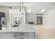 Large kitchen island with quartz countertops, stainless steel appliances, and modern fixtures at 6920 W Via Montoya Dr, Glendale, AZ 85310