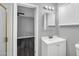Bright bathroom featuring a white vanity, updated fixtures, and view to adjacent bedroom at 7039 N 15Th St, Phoenix, AZ 85020